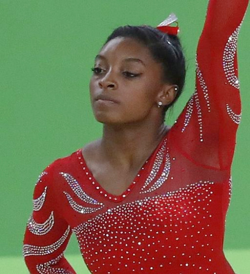 Simone Biles in red gymnastic outfit