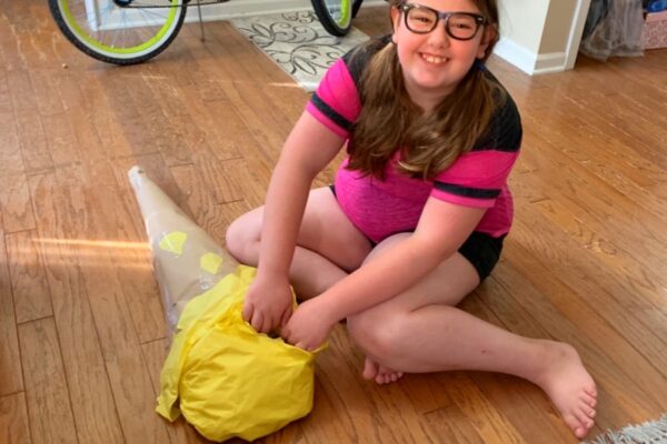 back to school cone shaped like an ice cream cone and a tween homeschool girl smiling and opening it