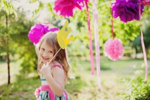 young girl with party decorations celebrating make up your own holiday day outside