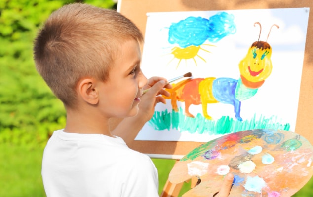 Flexible Homeschool Schedule with young boy painting outdoors during a homeschooling class