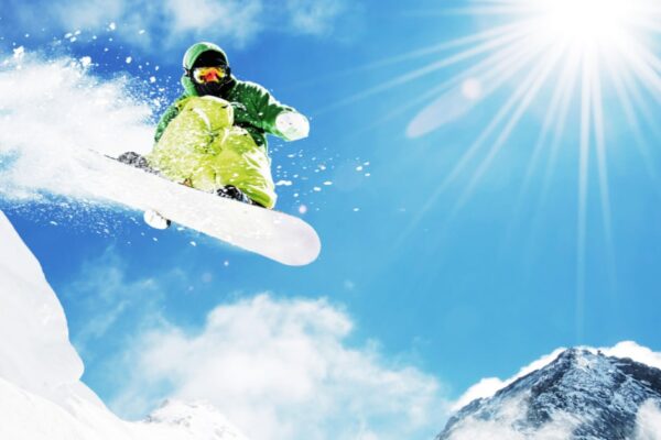 Winter Olympics Lesson Plans with snowboarding over a mountain with blue sky in background