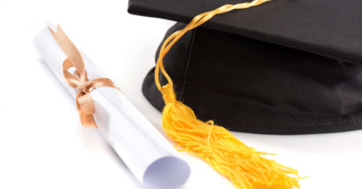 Homeschool Graduation Ceremony Tips plus Virtual Graduation Ideas [DIY Homeschool Graduation Guide] black graduation cap with graduation diploma scroll on a table