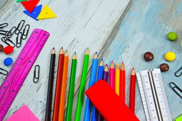 How To Use Back To School Sales to Stock Up for All Year school supplies on table like colored pencils rulers