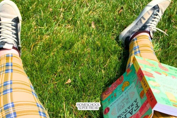 student studying in grass during summer with Julia Rothman book for summer school - homeschoolsuperfreak.com