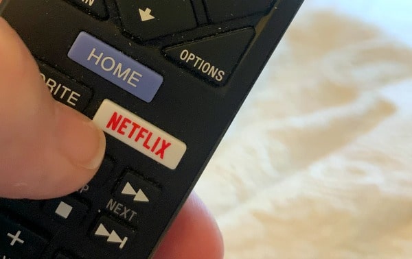 How To Use Netflix Party close up of a remote control showing a Netflix button