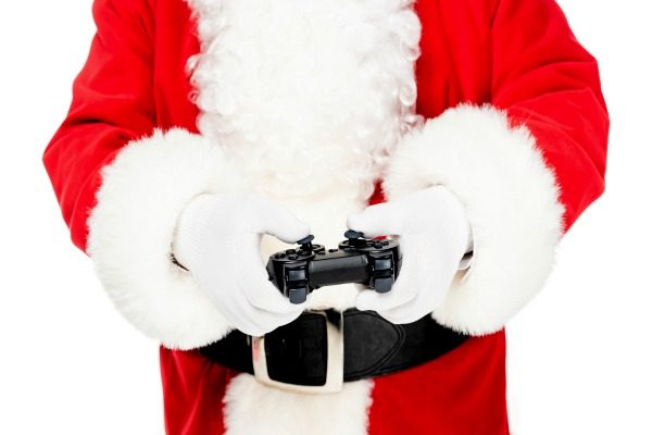 Budget Friendly Gamer Christmas Gifts for Kids and Teens (inexpensive gifts for gamers) Santa's hands holding a game controller