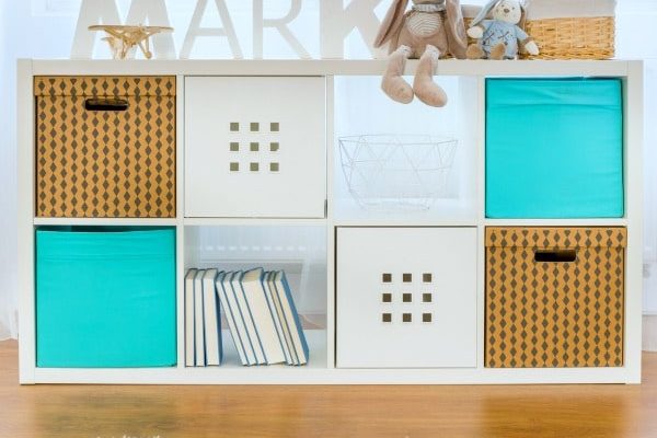 homeschool room essentials: organized child's room shelves with different colored bins