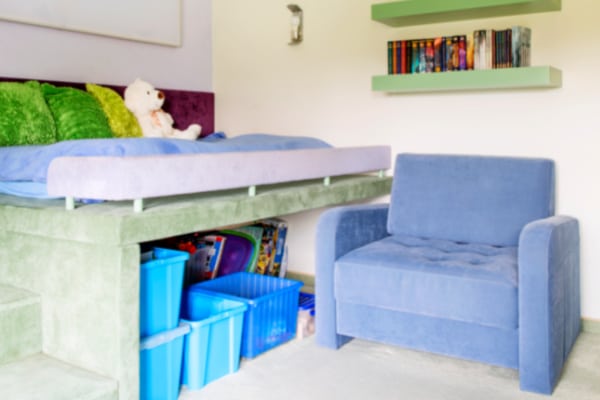Homeschooling In a Bedroom Idea Converted Bed Platform with homeschool supplies storage bins underneath and a chair