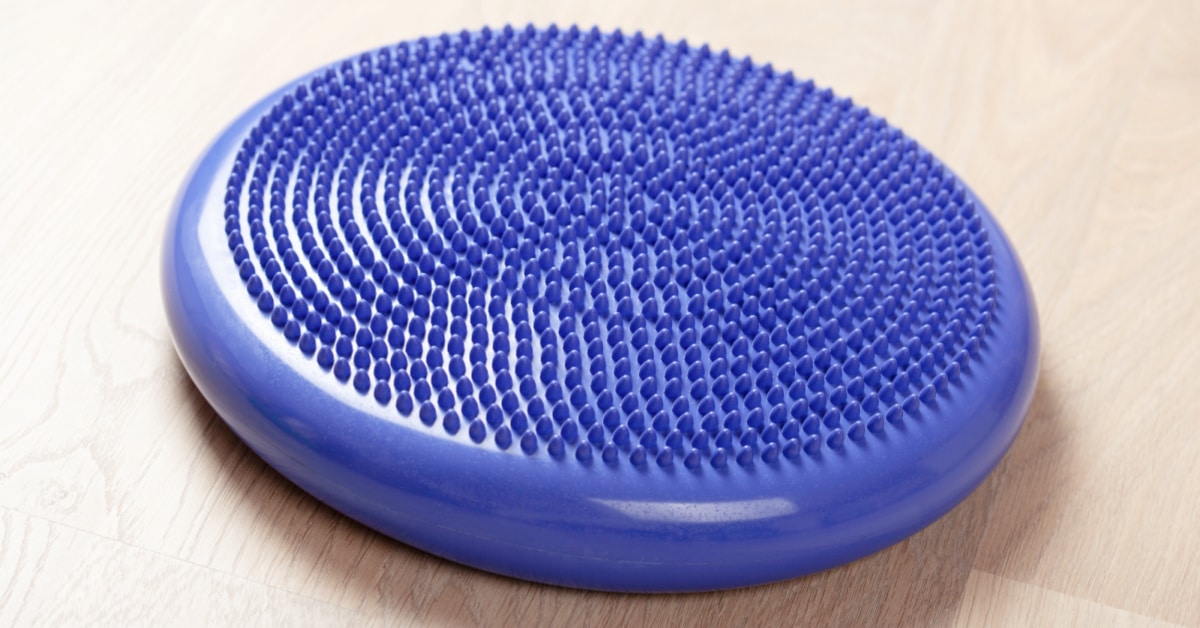 Blue Sensory Seating Cushion for Flexible Seat Learning sitting on a hardwood floor