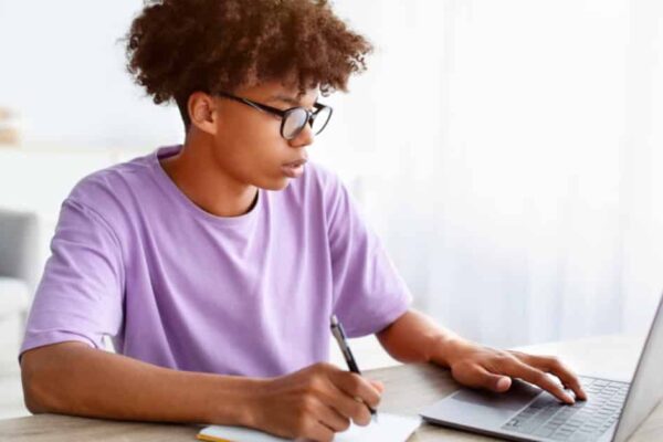 African American teen working on laptop Testing prep resources